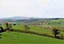 Views across undulating farmland towards distant Dartmoor