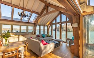 Beach End is an oak framed extension to a boathouse overlooking the River Dart by architects Harrison Sutton Partnership.
