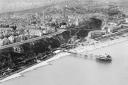 Folkestone from the air in the 1920s. This Aerofilms image shows the clifftop  setting of the prestigious Leas area. Note the old pier below (photo: Historic England)