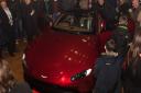 Guests look at the Aston Martin's new Vantage after its unveiling