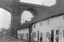 The Quay, Frodsham Bridge, 1900 to 1913, the railway viaduct towers over the white cottages on the quayside.