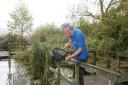 Jon Carter, Visitor Experience Manager at RSPB Leighton Moss checking the reserves pond