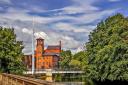 Derby Silk Mill with the needle mast of Cathedral Green footbridge