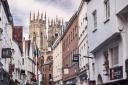 The City of York in winter, a view along Low Petergate, with its many shops and boutiques, to York Minster. (c) travellinglight / Alamy Stock Photo