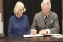 The royal couple sign the visitors' book at Ferens Art Gallery