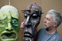 Darrell Wakelam with some large face masks he created for his new book Art Shaped