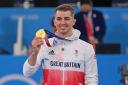 Max Whitlock show his gold medal in Toyko. Credit Garry Bowden/Sport in Pictures
