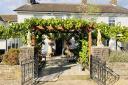 The Greyhound Inn in summer with its vine covered outdoor dining area.