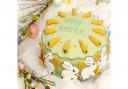 Easter carrot cake decorated with pale green sugar paste and decorated with white rabbits and 11 carrots to represent the 11 apostles - an alternative to simnel cake