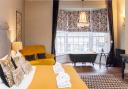The Plush Room, with roll-top bath in the bow window with views of the high street in Dorchester