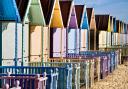 THE NEW BEACH HUTS AT WEST MERSEA, ESSEX, ALL PAINTED IN PASTEL COLOURS