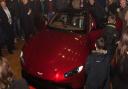 Guests look at the Aston Martin's new Vantage after its unveiling