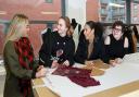 Students, Molly Sutcliffe, Molly Tuck, Charlee Watson and Nieve Fernandez-Torrella busy pattern cutting