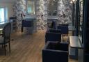 The salon looks smart and stylish with a feature wall and new lighting scheme