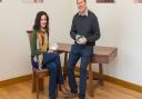 Silversmith Karina Gill and furniture designer-maker Simon Thomas Pirie. Karina is seated on a Gabriel chair in elm and English walnut and Simon is leaning on one of his Makers’ Eye desks in black walnut.
