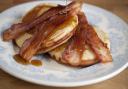 Fat fluffy pancakes with syrup and bacon