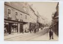 Salisbury Street in Blandford, photographed by Thomas (Tom) Nesbitt (1850-1917) showing his shop on the left. He lived in Blandford all his life and often took photos of his home town which were made into postcards