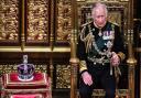 Charles, Prince of Wales sits by the The Imperial State Crown in the House of Lords Chamber