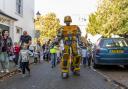 A giant robot in the streets of Sidmouth draws attention to the festival last year. Photo: Pete Bond
