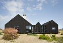 The Shingle House's cladding echoes the tar-clad walls of the fishermen's cottages nearby. Credit: Living Architecture