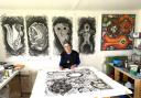 Christine in her studio at Lyme Regis with some of her Treasure drawings behind her. (PHoto: