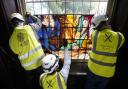 A framed section of a newly conserved 18th-century painted glass window is installed in the Gothic 'tomb' at the National Trust's The Vyne near Basingstoke