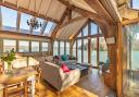 Beach End is an oak framed extension to a boathouse overlooking the River Dart by architects Harrison Sutton Partnership.