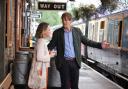 Actors Kris Marshall and Sally Bretton on the platform at South Devon Railway for BBC One's new series of Beyond Paradise