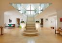 The entrance hall, with bespoke dividing staircase made of Cotswold stone