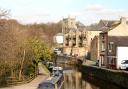 A branch of the Leeds Liverpool Canal runs alonside the stone buildings in Skipton in the Yorkshire Dales..