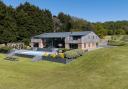 Barn-style house with landscaped lawn, terrace and outdoor pool
