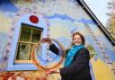 Glassmaker / illiustrator Shen Chokyi with some of her glasswork next to her Thomas Telford built cottage near Eskdalemuir