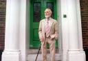 Sir John Mills stands on the doorstep of the former Norwich High School for Boys, in Upper St. Giles Street.