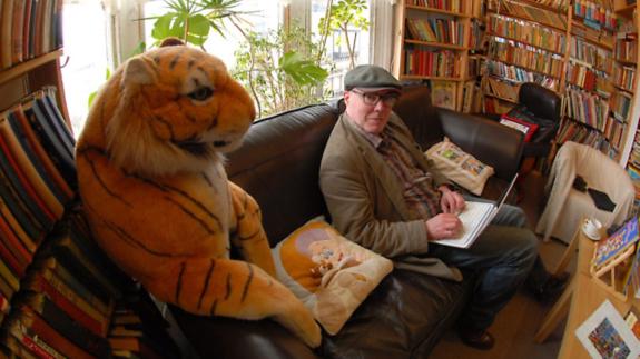 Great British Life: Relaxing in the cafe area: The 'house tiger' makes sure writer Andrew Griffiths pays him the attention he deserves! Great British Life: Relaxing in the cafe area: The 'house tiger' makes sure writer Andrew Griffiths pays him the attention he deserves!