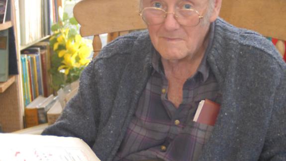 Great British Life: Alistair with one of the older books in their collection, dating from the 1600s Great British Life: Alistair with one of the older books in their collection, dating from the 1600s