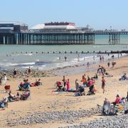 Families love the beach at Cromer, with its famous pier in the background