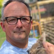 Terry Hayden at his Loddon home with one of his temporary charges, a rabbit the family is fostering for the RSPCA