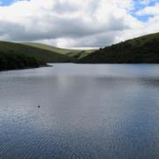 The serene waters of Meldon Reservoir on Dartmoor.