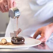 Experience sweet delights like this cocoa biscuit with Maldon salt crémeux, milk chocolate foam and salted caramel sauce.