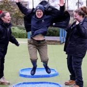Grown up fun too, Sue Kinsey puddle jumping, cheered by colleagues Alice Litchfield and Becky Titchard, from the WWT Slimbridge education and engagement team, who organise the puddle jumping championships.