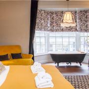 The Plush Room, with roll-top bath in the bow window with views of the high street in Dorchester