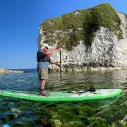 Paddle boarding at Old Harry Rocks in excellent weather conditions, always check weather and tides before setting off