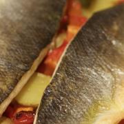 Baked sea bass with potatoes, peppers and preserved lemons