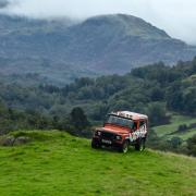 One of the off-roaders from Ambleside based Kankku stands with the Langdale Pikes as a backdrop.  PICTURES by MILTON HAWORTH.