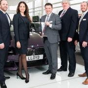 Mark Powell, Head of Business at Lloyd BMW Blackpool, pictured with the BMW Retailer of the Year award, alongside staff.