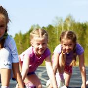 Four pre-teen girls starting to run on track