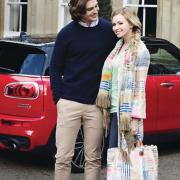 Barney models a Tommy Hilfiger New York Fit White Oxford Shirt, £75, with French Connection Mozart Marine Blue Jumper, £50 and Tommy Hilfiger Denton Chino, £100, all from Stringers. Olivia joins him wearing a Riani Frock Coat, £599, with Riani Green