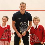 Champion squash player Nick Matthew with Giggleswick Junior School pupils