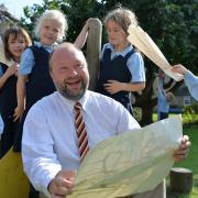 Dr David Moses has fun with some of the younger members of his independent Catholic school