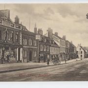 West Street in Bridport, south side. W Frost published The Bridport News & Dorset, Devon and Somerset Advertiser. Beyond is the Sun Hotel, Amanda Spiller's confectioner and milliner, William Warren's china and glass, Frederick and Ernest Best Outfitters